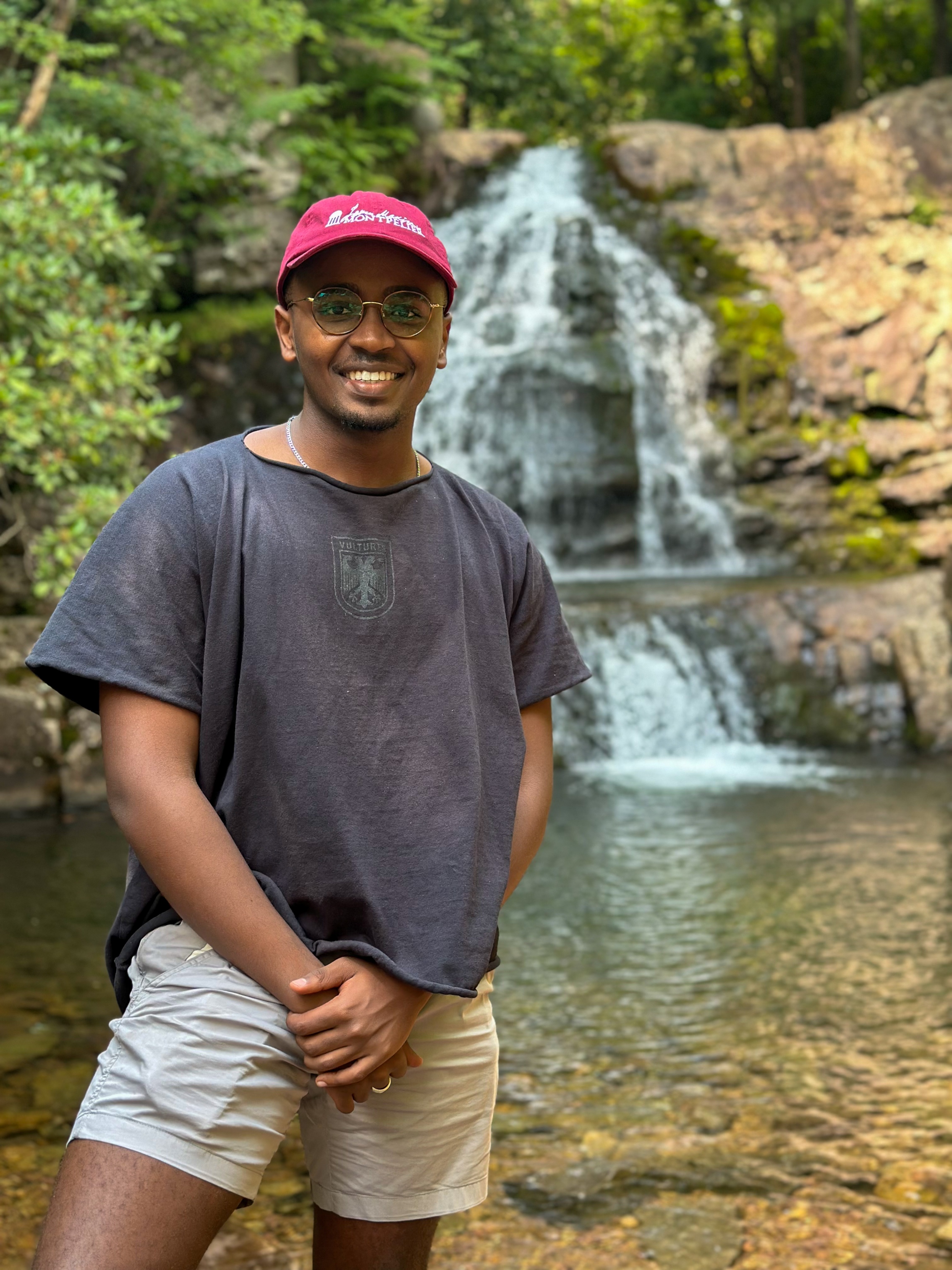 Henry Twagirayezu, Student Success Coach, at the waterfall
