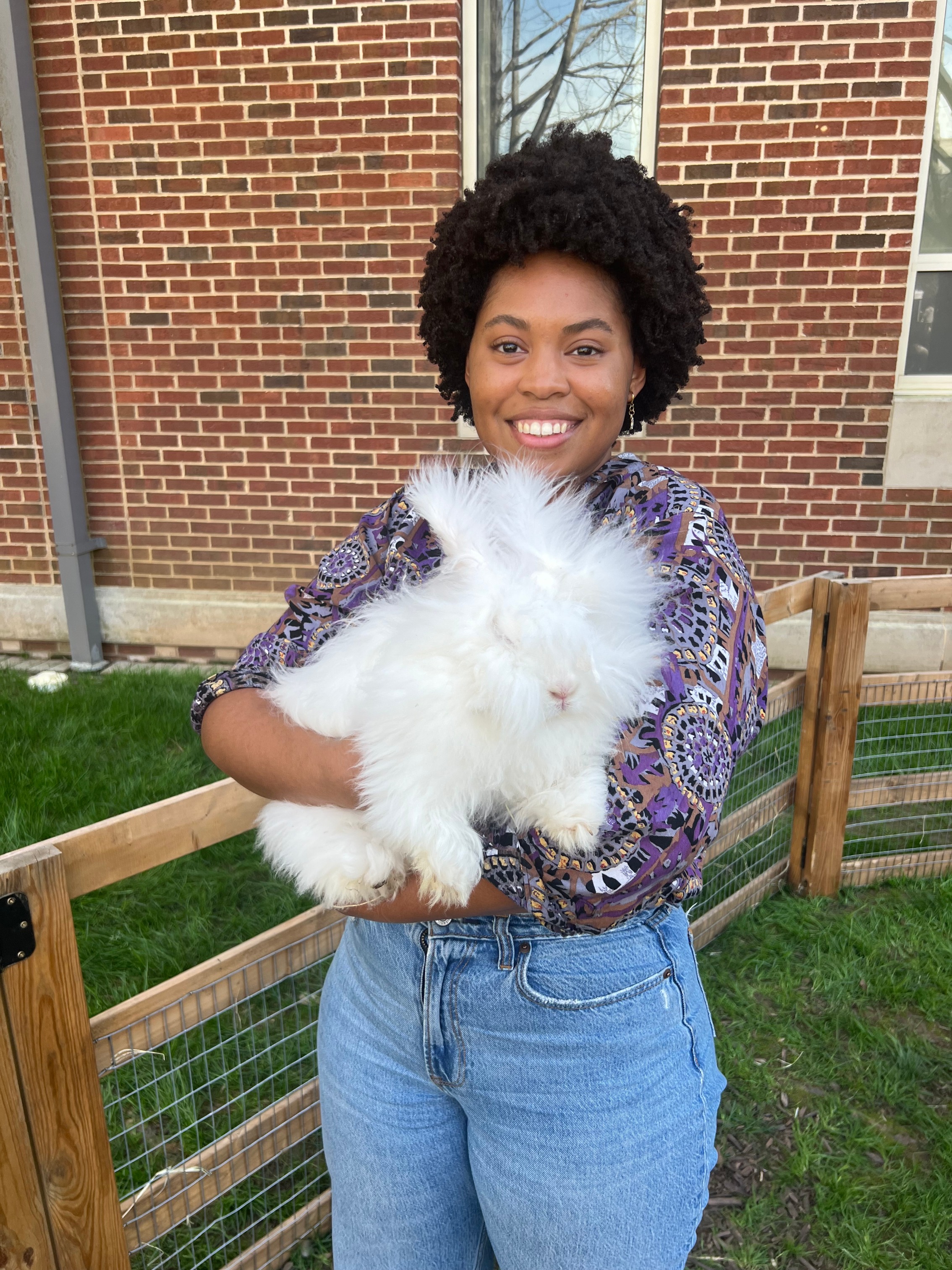 Logan Felton, Student Success Coach, holding her cat